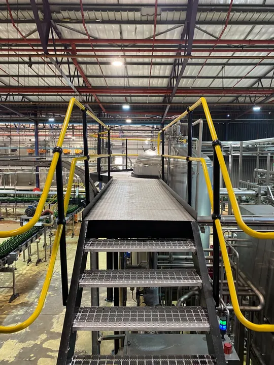 Elevated access walkway inside an industrial processing facility