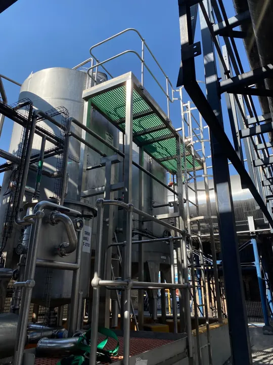 Industrial pipework positioned around process vessels and access platforms